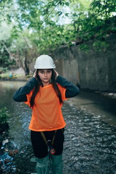 A young female digger walks along a rain collector
