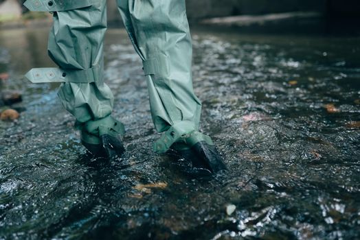Close up view of waterproof pants boots in water