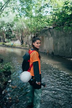 A young female digger walks along a rain collector
