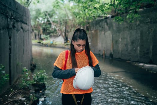 A young female digger walks along a rain collector