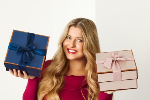 Happy woman holding gifts for birthday, anniversary, wedding, Valentines day or Christmas, luxury holiday present or beauty box subscription delivery concept