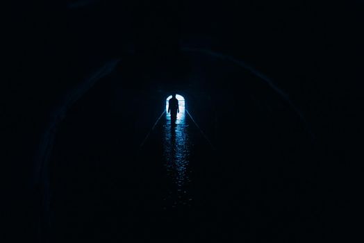 Silhouette of a woman in a tunnel. Exit