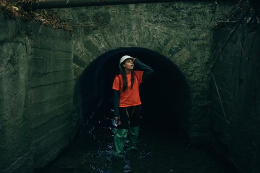 A young female digger walks along a rain collector