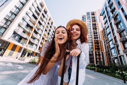 Two women are looking at the camera on the street