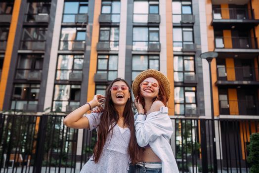 Two lovely girl friends hugging and having fun.