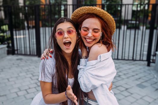 Two lovely girl friends hugging and having fun.