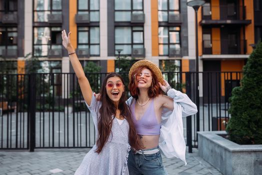 Two lovely girl friends hugging and having fun.