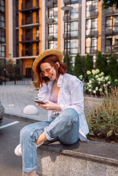 Photo of cute adorable young lady sitting stairs typing modern device outside urban city street