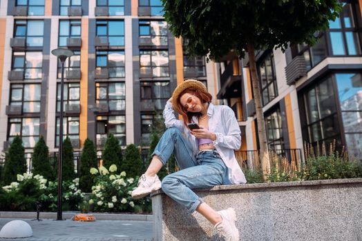 Photo of cute adorable young lady sitting stairs typing modern device outside urban city street