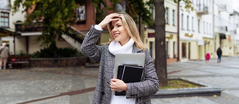 adult stylish woman financial analyst with laptop goes to the office.