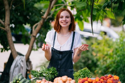 Woman seller at the counter with vegetables.