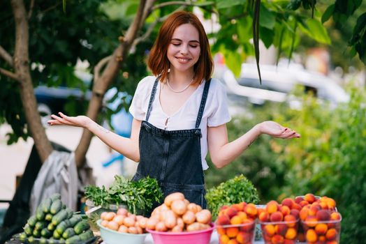 Woman seller at the counter with vegetables.