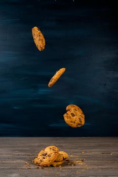 chocolate cookies levitating on black background