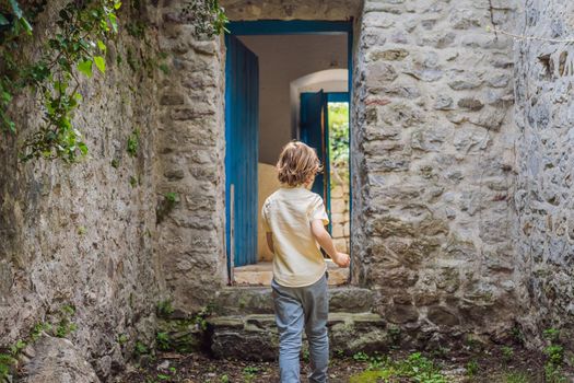 Boy tourist walks through the old town of Bar in Montenegro. Happy tourist walks in the mountains. Suburbs of the city of Bar, Montenegro, Balkans. Beautiful nature and landscape.