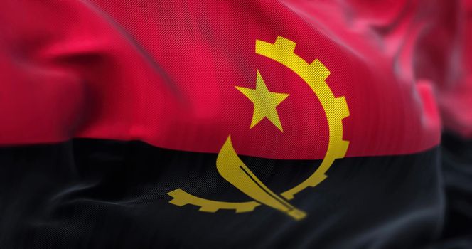 Close-up view of the Angola national flag waving in the wind. The Republic of Angola is a country located on the west coast of Southern Africa. Fabric textured background. Selective focus