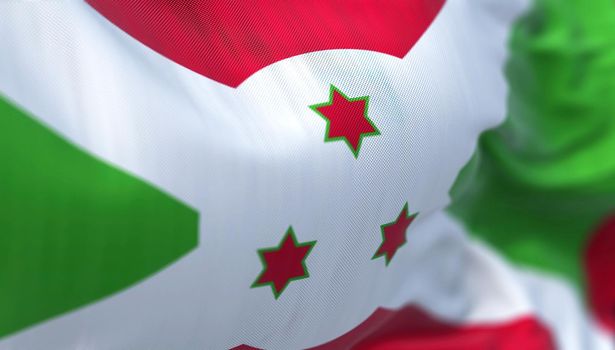 Close-up view of the Burundi national flag waving in the wind. The Republic of Burundi is a country located in the east Africa. Fabric textured background. Selective focus