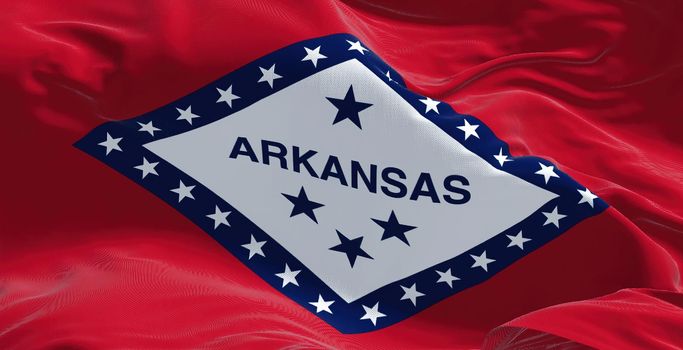 Close-up view of the Arkansas state flag waving in the wind. Arkansas is a landlocked state in the South Central United States. Fabric textured background. Confederate US state