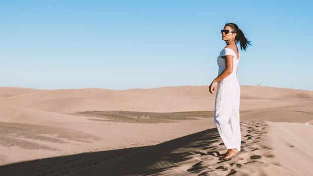 young woman at the dessert of Maspalomas sand dunes Gran Canaria during vacation at the Canary Islands. in Spain, Gran Canaria sand dunes