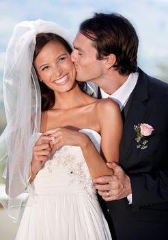 He cant get enough of his new bride. A bride and groom on their wedding day