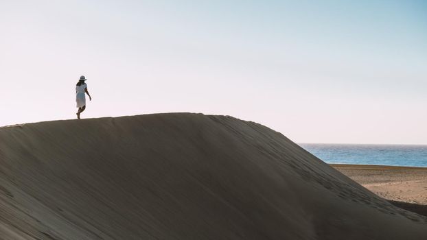 young woman at the dessert of Maspalomas sand dunes Gran Canaria during vacation at the Canary Islands. in Spain, Gran Canaria sand dunes