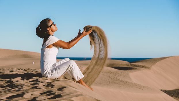 young woman at the dessert of Maspalomas sand dunes Gran Canaria during vacation at the Canary Islands. in Spain, Gran Canaria sand dunes