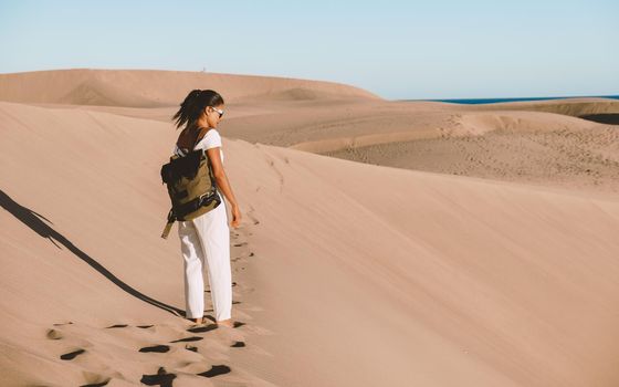 young woman at the dessert of Maspalomas sand dunes Gran Canaria during vacation at the Canary Islands. in Spain, Gran Canaria sand dunes