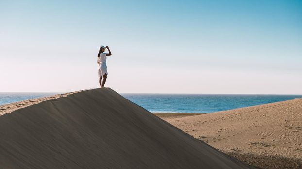 young woman at the dessert of Maspalomas sand dunes Gran Canaria during vacation at the Canary Islands. in Spain, Gran Canaria sand dunes