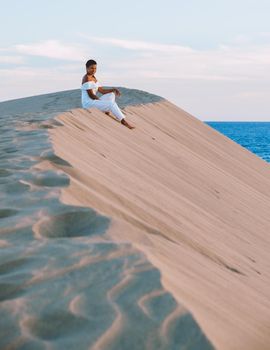 young woman at the dessert of Maspalomas sand dunes Gran Canaria during vacation at the Canary Islands. in Spain, Gran Canaria sand dunes