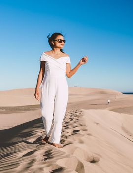 young woman at the dessert of Maspalomas sand dunes Gran Canaria during vacation at the Canary Islands. in Spain, Gran Canaria sand dunes