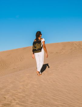 young woman at the dessert of Maspalomas sand dunes Gran Canaria during vacation at the Canary Islands. in Spain, Gran Canaria sand dunes