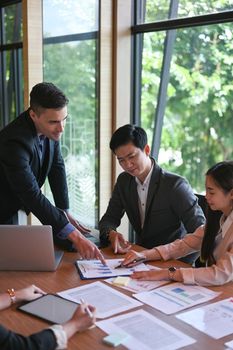 Businessman explaining business plans to his colleagues during meeting.