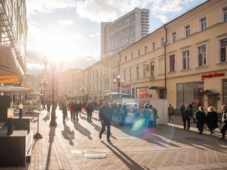 MOSCOW, RUSSIA - September 17, 2022. Local people and tourists walk on famous Arbat street. Autumn sunset over historical center of capital.