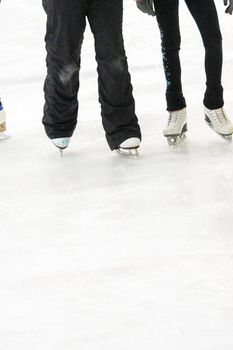 View of a figure skater and her coach feet at the figure skating practice.