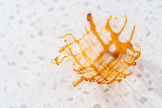 Crunchy caramel cupcake toppers on the counter.