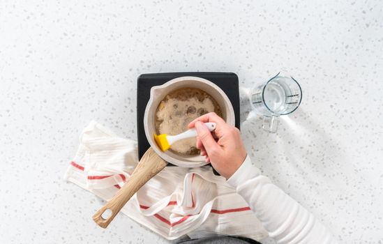 Flat lay. Caramelizing sugar in a saucepan to make caramel cupcake toppers.