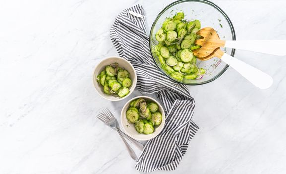 Flat lay. Summer cucumber salad in small ceramic bowls.