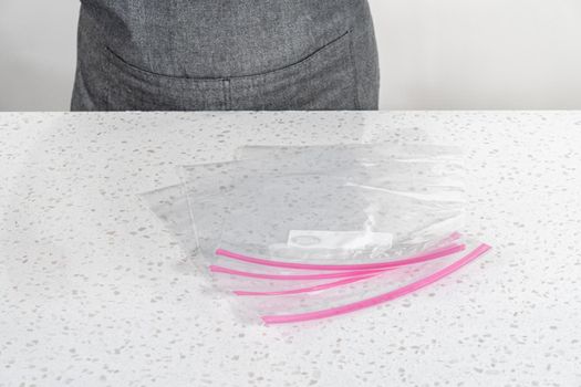 Empty plastic bags to package homemade frozen shrimp scampi meal prep.