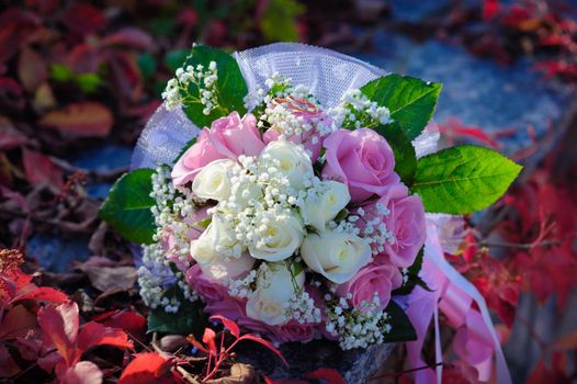 Bridal wedding bouquet of flowers. Wedding bouquet of pink and white roses lying on a grass.