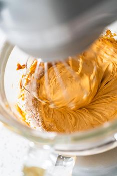 Whipping ingredients in a stand electric mixer to make dulce de leche buttercream frosting.