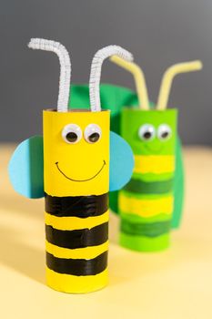 Papercraft project. Colorful bugs made out of empty toilet rolls.
