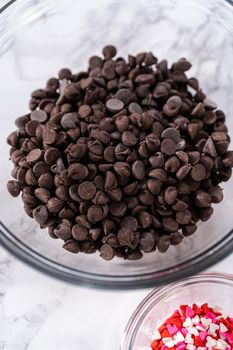 Measured ingredients in a glass mixing bowl to prepare chocolate covered strawberries.