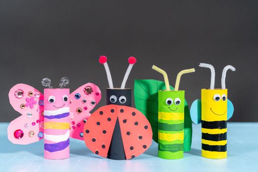 Papercraft project. Colorful bugs made out of empty toilet rolls.