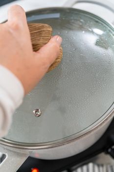 Boiling water in a large cooking pot to prepare linguine pasta.