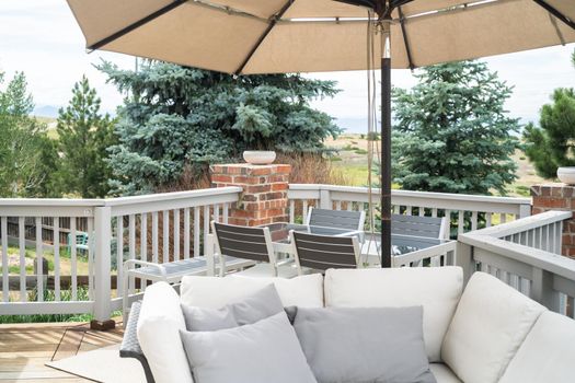 Patio of a luxury single-family home furnished with modern furniture.