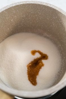 Caramelizing sugar in a saucepan to make caramel cupcake toppers.