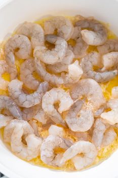 Cooking shrimp in a nonstick frying pan to make shrimp scampi with linguine pasta.