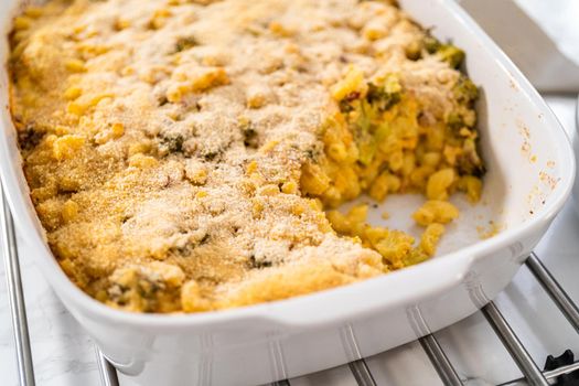 Serving freshly made macaroni and cheese with broccoli.