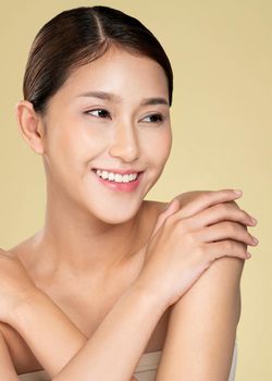 Portrait of ardent young woman with healthy clear skin and soft makeup looking at camera and posing beauty gesture. Cosmetology skincare and beauty concept.