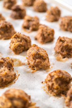 Cooling homemade oven-baked meatballs on the kitchen counter.