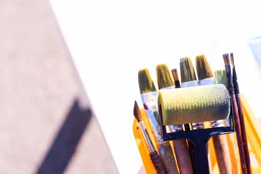 Painting tools on white background. Paint rollers, brushes.